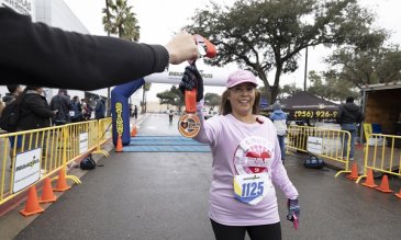 5k participant being handed their medal
