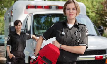 EMS professional in front of ambulance