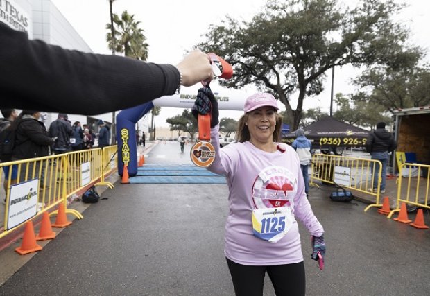 5k participant being handed their medal