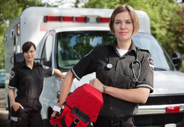 EMS professional in front of ambulance